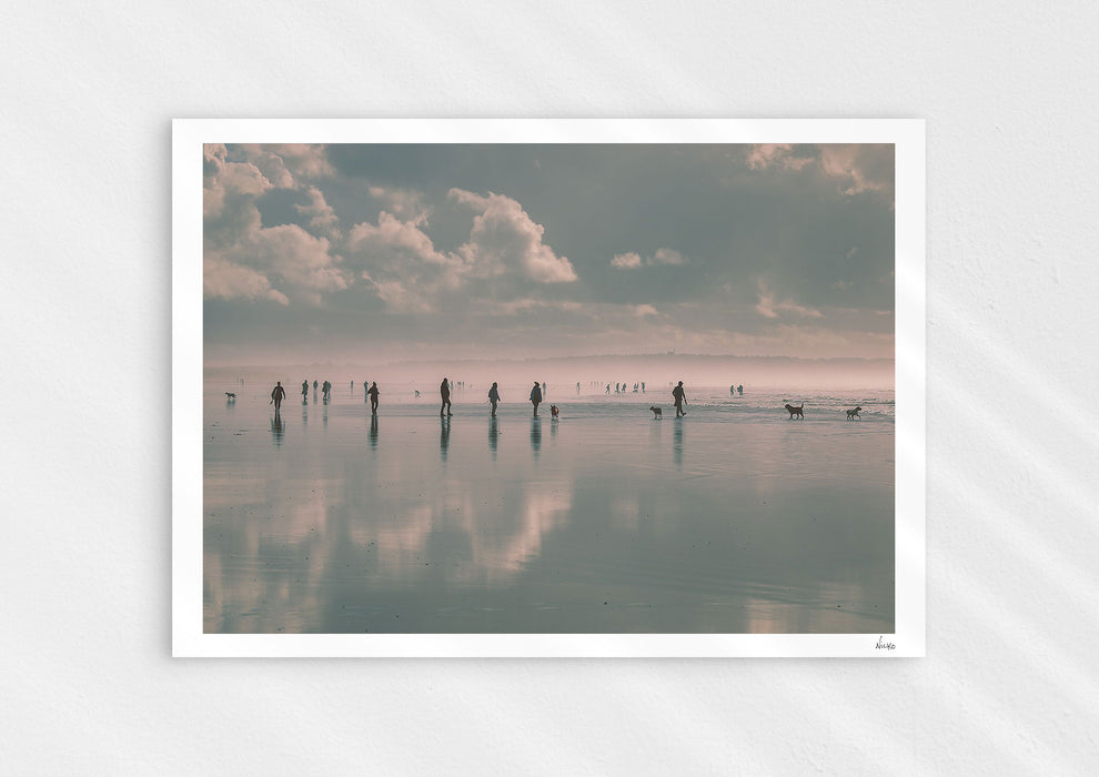Beach Fever, a colour photographic print depicting the sky and people reflected on Saunton Sands.