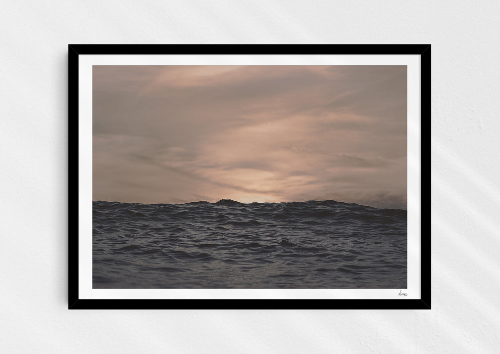 Crinkles With Colour, a colour photographic print of a peaceful ocean at Polzeath, Cornwall in a black frame.