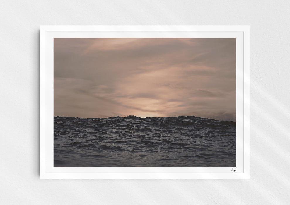 Crinkles With Colour, a colour photographic print of a peaceful ocean at Polzeath, Cornwall in a white frame.