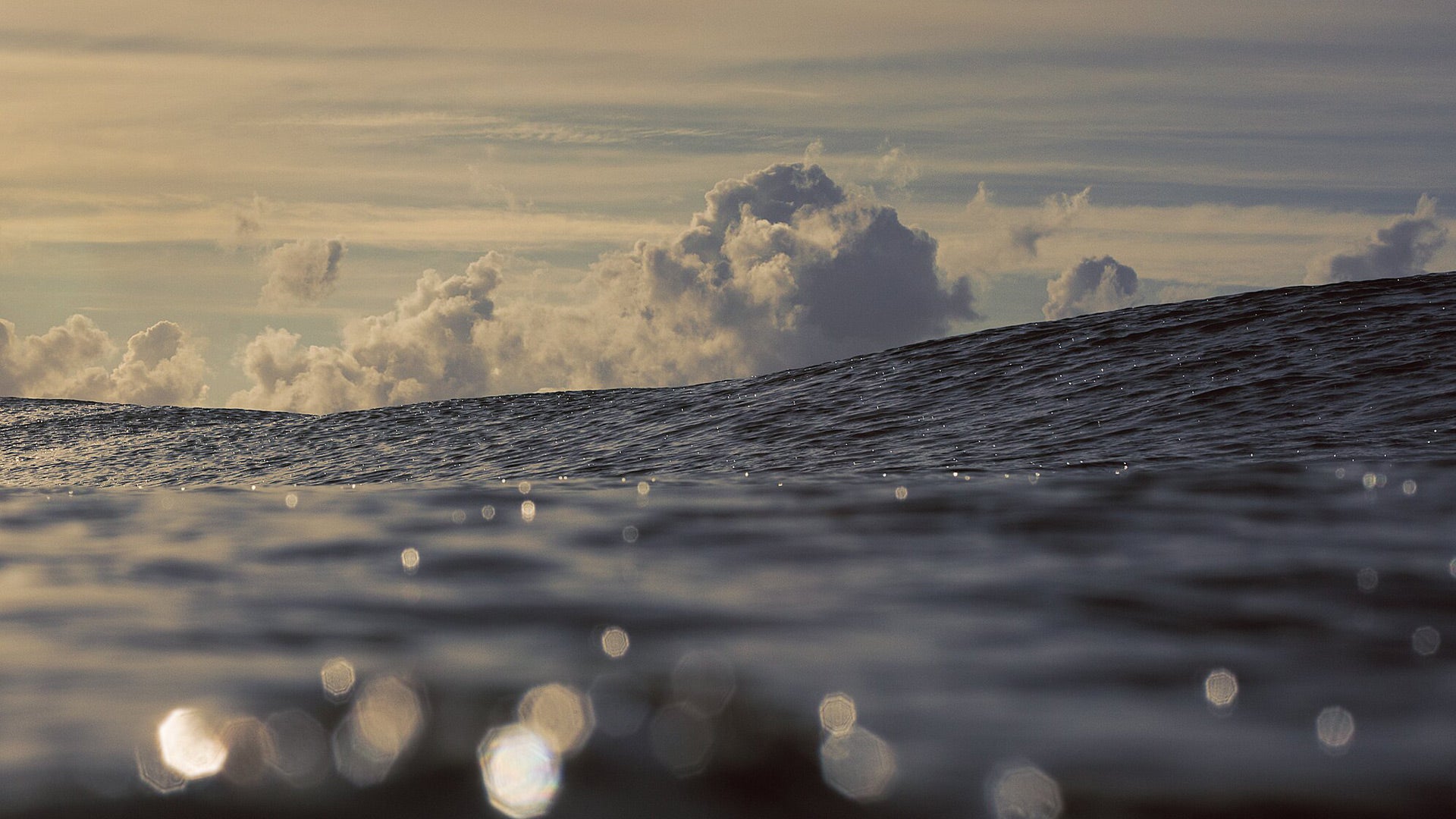 The glistening sea with beautiful billowy clouds