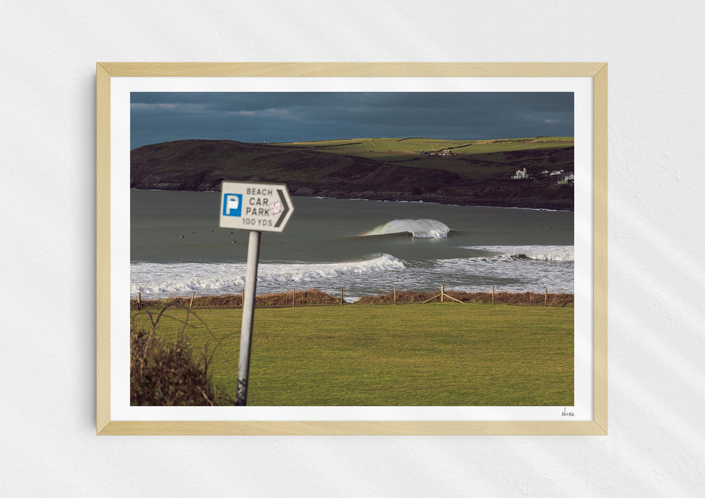 Delivery Bowls, a fine art photo print of a barrelling wave at Croyde Bay in Devon in a wood frame.