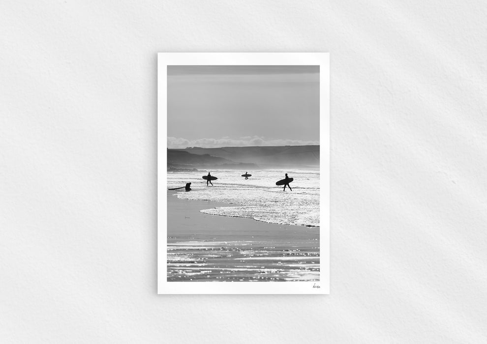 Entry Exits, a black-and-white photo print of surfers on the beach Polzeath, Cornwall.