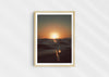Gold Stripe, a colour photographic print of the sun at the ocean horizon at Croyde Bay, Devon in a wood frame.