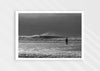Into the Tempest, a colour photographic print of a surfer facing a breaking wave at Croyde Bay in Devon.
