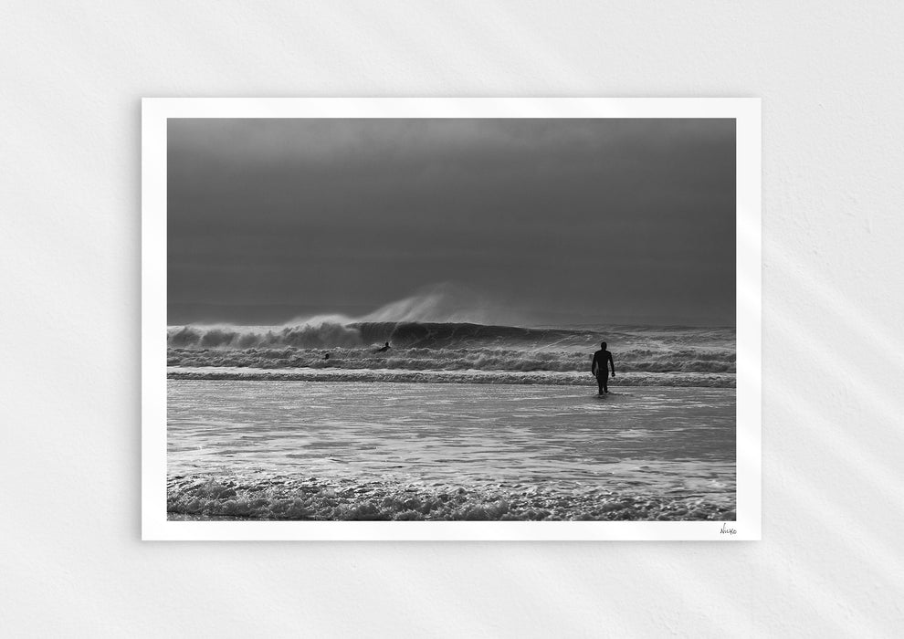 Into the Tempest, a colour photographic print of a surfer facing a breaking wave at Croyde Bay in Devon.