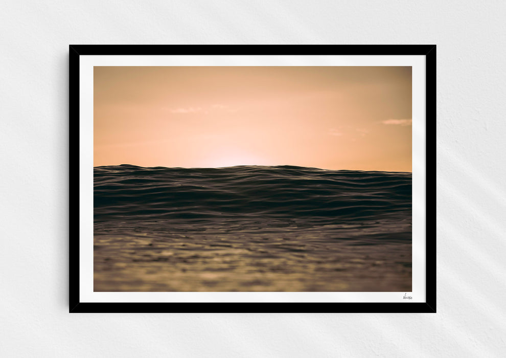Light Life, a colour photographic print of dusk over calm ocean at Woolacombe, Devon in a black frame.