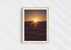 Light in the Deep, a colour photographic print of the sun on the ocean horizon at Porthtowan, Cornwall in a wood frame.