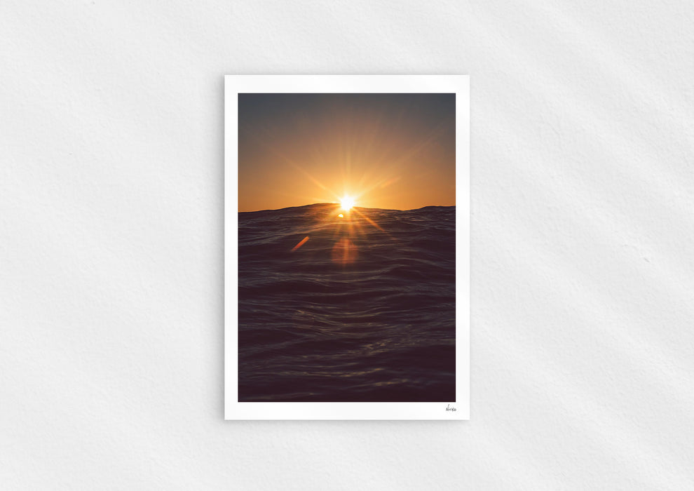 Light in the Deep, a colour photographic print of the sun on the ocean horizon at Porthtowan, Cornwall.