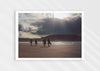 Mutual People, a colour photographic print of surfers walking across sand in northern Scotland.