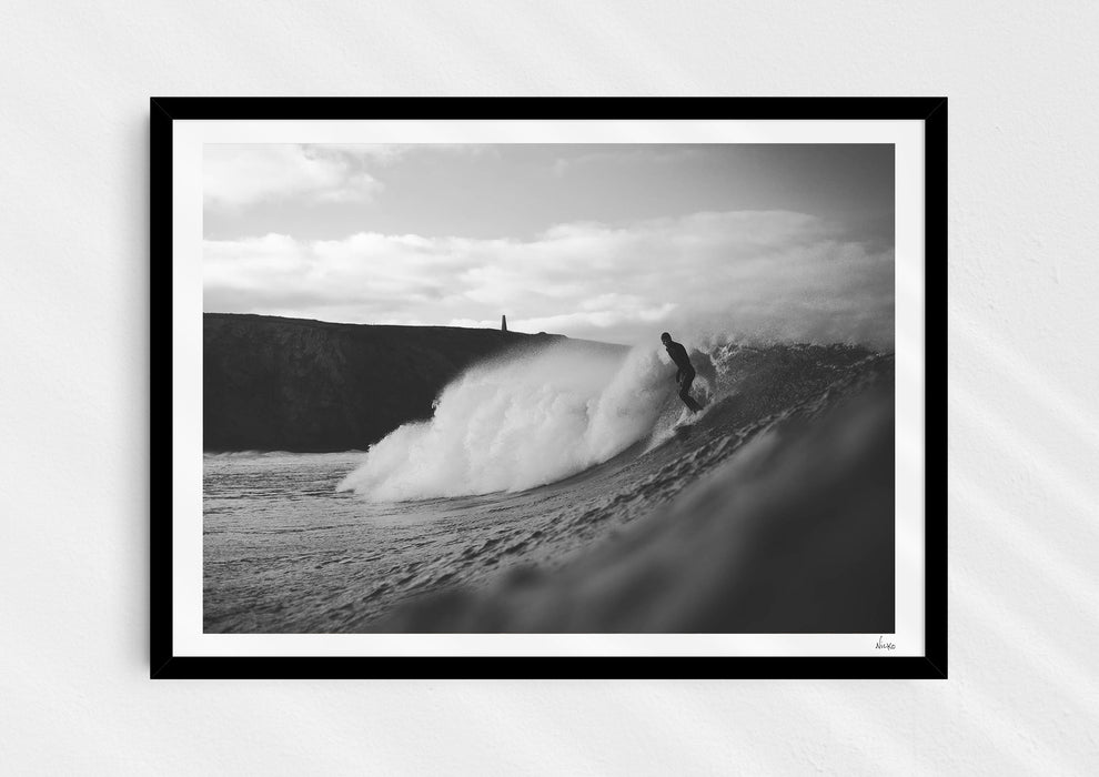 Nowhere To Hide, a black-and-white photo print of a surfer on a wave in Porthtowan, Cornwall in a black frame.
