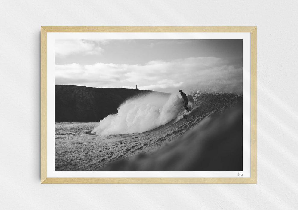 Nowhere To Hide, a black-and-white photo print of a surfer on a wave in Porthtowan, Cornwall in a wood frame.