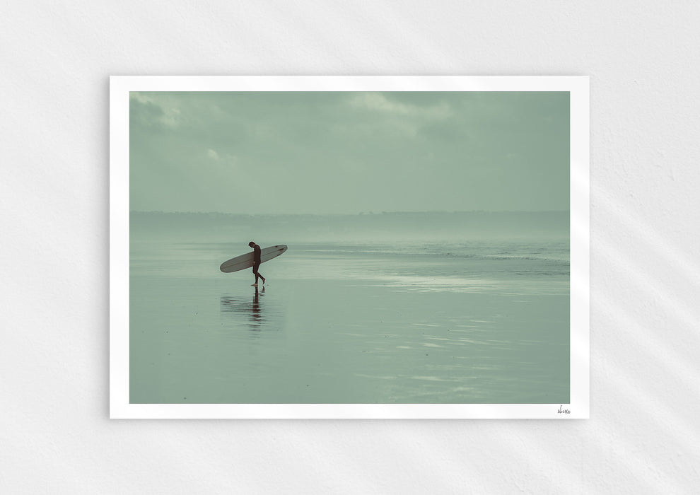 Sea Wanderer, a colour photographic print of a surfer walking across Saunton Sands, Devon.