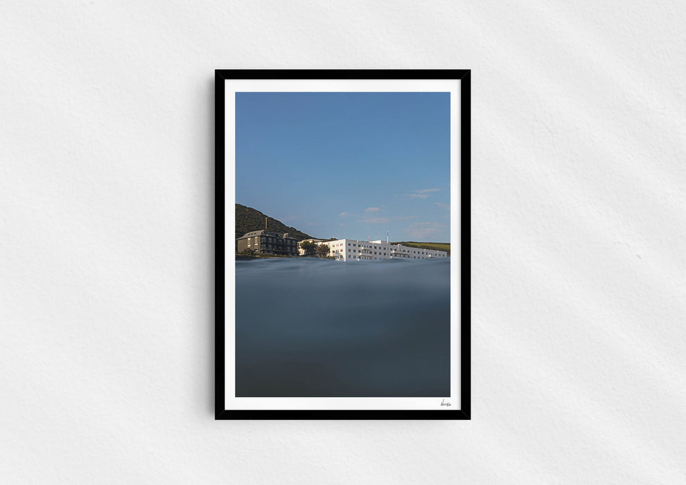 Sea With Hotel Views, a colour photographic print of Saunton Sands Hotel shot from the sea in a black frame.
