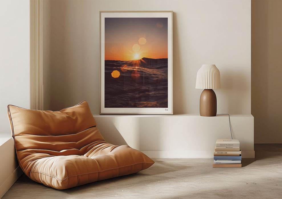 Solar Flare, a colour photographic print of sunlight on the ocean at Porthtowan, Cornwall in a frame against a living room wall.