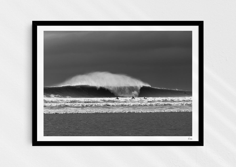 Untamable, a fine art photographic print depicting a barrelling wave with spray at Croyde Bay in Devon in a black frame.