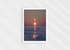 We’ll Meet Again, a colour photographic print of a bird and sunset over a calm ocean.