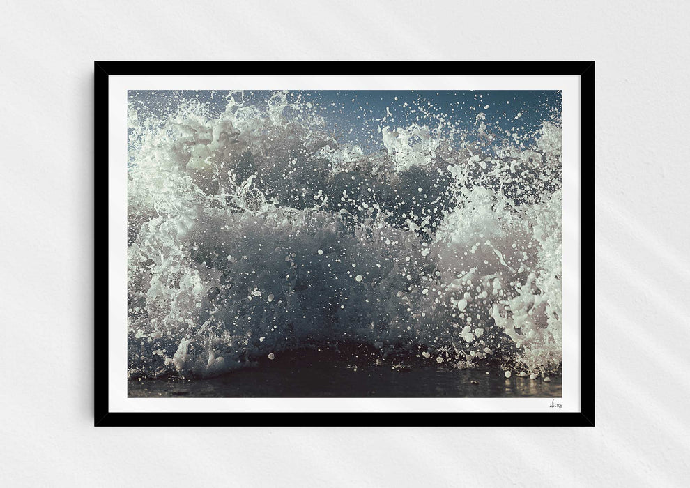 What We Sea, a colour photograph of white water from a sea-level perspective in a black frame.