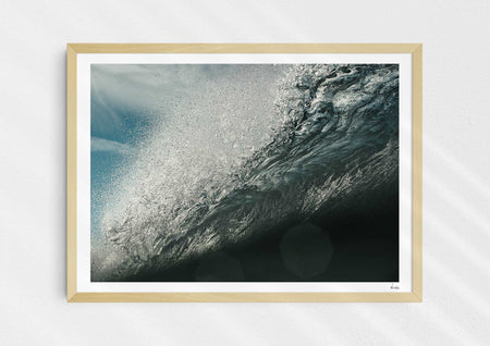 Wild Seductive, a colour photographic print of water droplets suspended over a wave in the Azores in a wood frame.